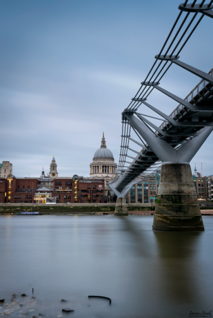 Portrait image of St Pauls and Millennium bridge.